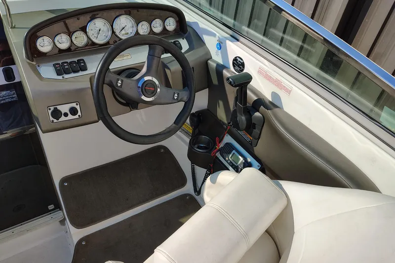 Slide: The Image of 2006 Regal 2250 Cuddy boat cockpit with steering wheel and instrument panel. - 2