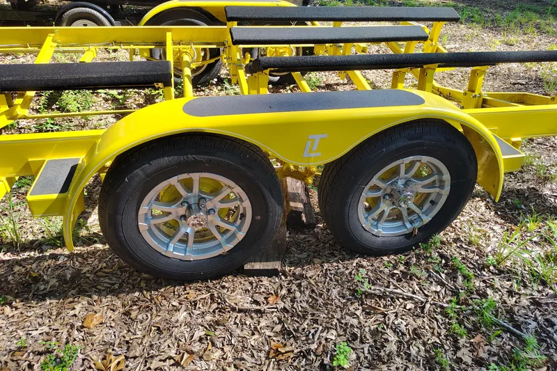 Slide: The Image of Yellow boat trailer with dual wheels for 2006 Regal 2250 Cuddy. - 25