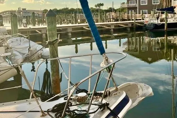 Slide: The Image of 1978 Morgan 415 sailboat docked in a serene marina setting. - 10