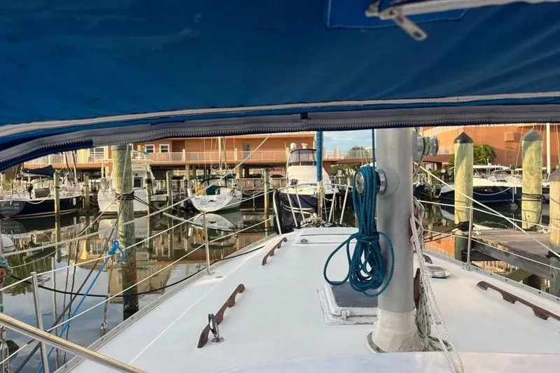 Slide: The Image of 1978 Morgan 415 sailboat docked in a marina, surrounded by other boats. - 14