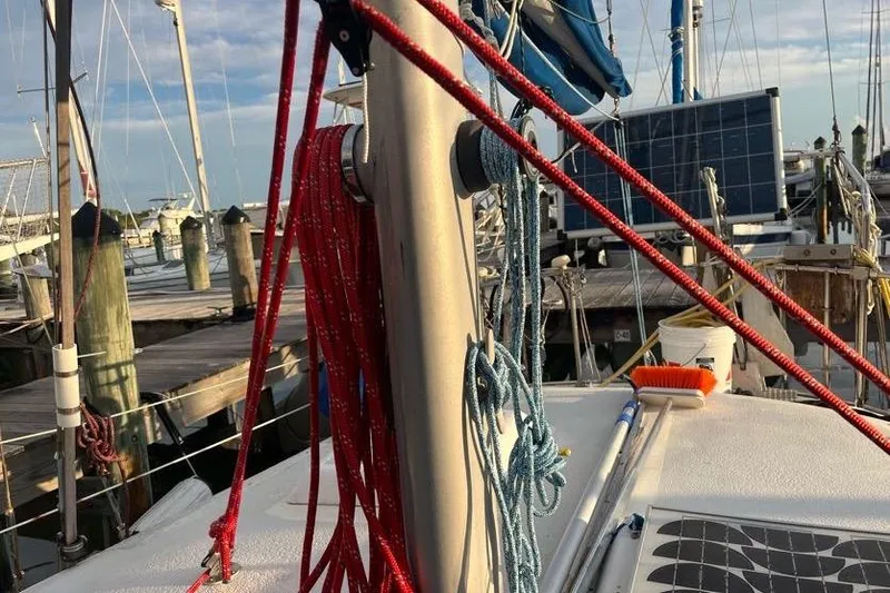 Slide: The Image of 1978 Morgan 415 sailboat deck with ropes and solar panel at marina. - 16