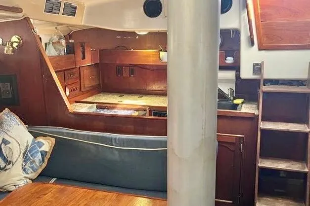 Slide: The Image of 1978 Morgan 415 yacht interior with wooden cabinetry and cozy seating area. - 17
