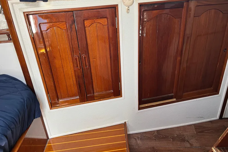 Slide: The Image of 1978 Morgan 415 interior with polished wooden cabinets and flooring. - 23