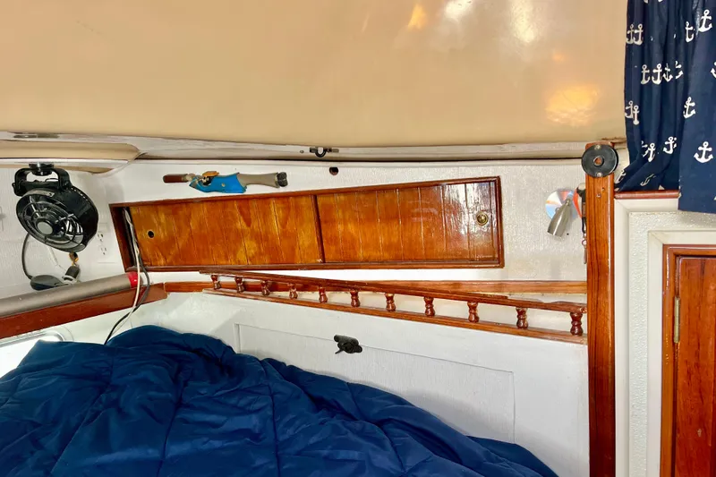 Slide: The Image of 1978 Morgan 415 yacht interior with wooden cabinets and nautical-themed decor. - 25