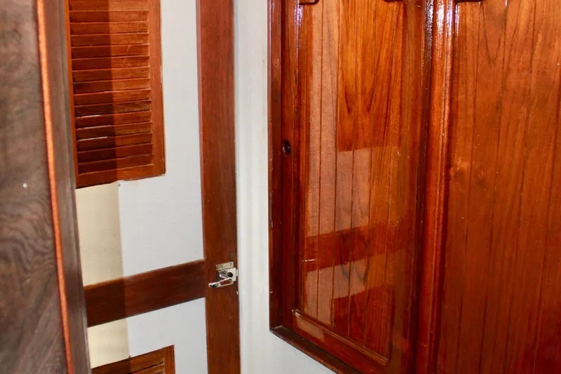 Slide: The Image of Interior of a 1978 Morgan 415 sailboat featuring polished wooden cabinetry and paneling. - 33