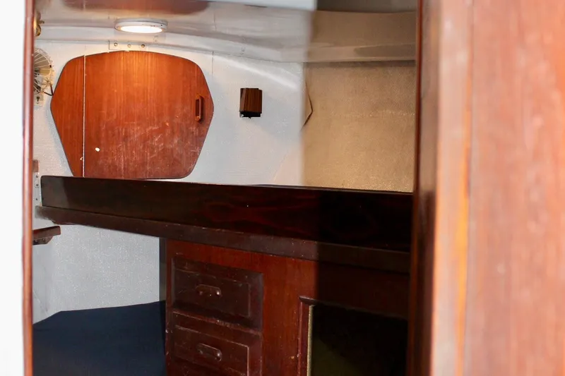 Slide: The Image of 1978 Morgan 415 yacht interior with wooden cabinetry and cozy cabin space. - 34