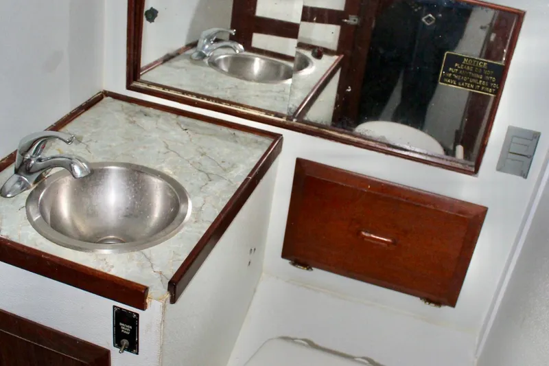 Slide: The Image of 1978 Morgan 415 yacht bathroom with sink, mirror, and wooden cabinetry. - 36