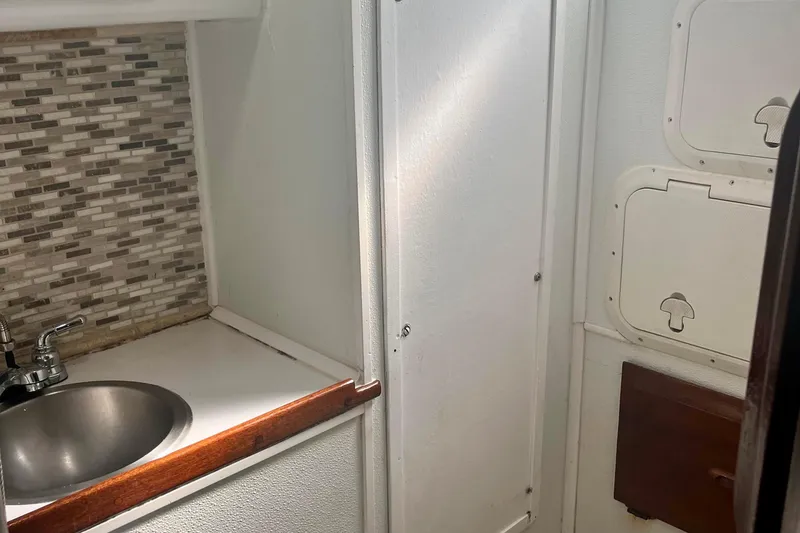 Slide: The Image of 1978 Morgan 415 yacht interior with sink, mosaic backsplash, and storage compartments. - 37