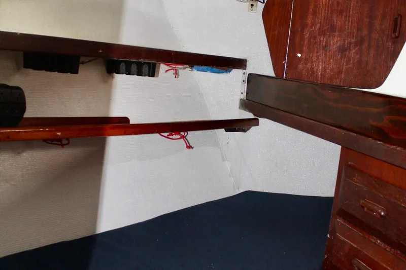 Slide: The Image of Interior of a 1978 Morgan 415 sailboat with wooden shelves and cabinetry. - 39