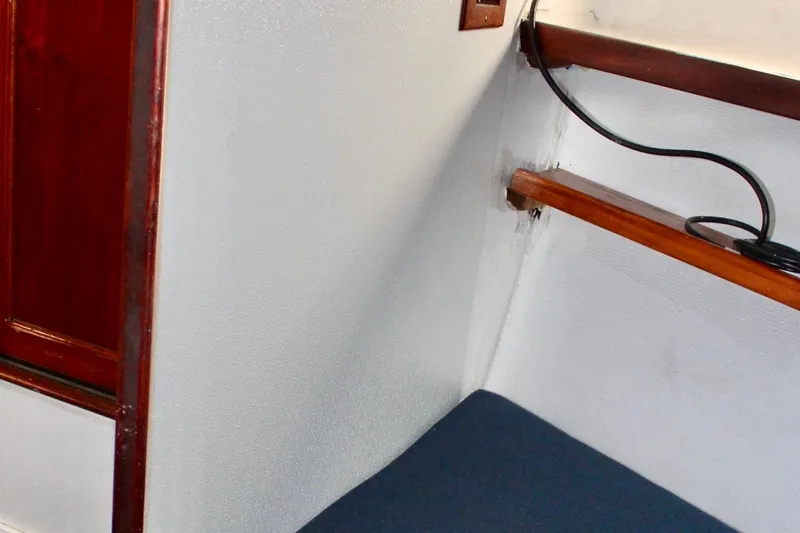 Slide: The Image of Interior of a 1978 Morgan 415 sailboat, featuring wooden trim and seating area. - 40