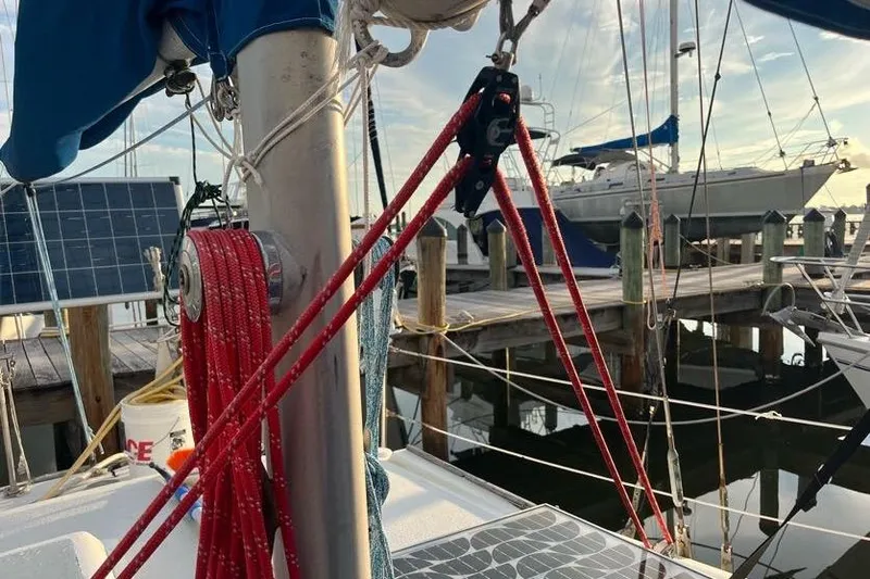 Slide: The Image of 1978 Morgan 415 sailboat at dock with red ropes and solar panels. - 7