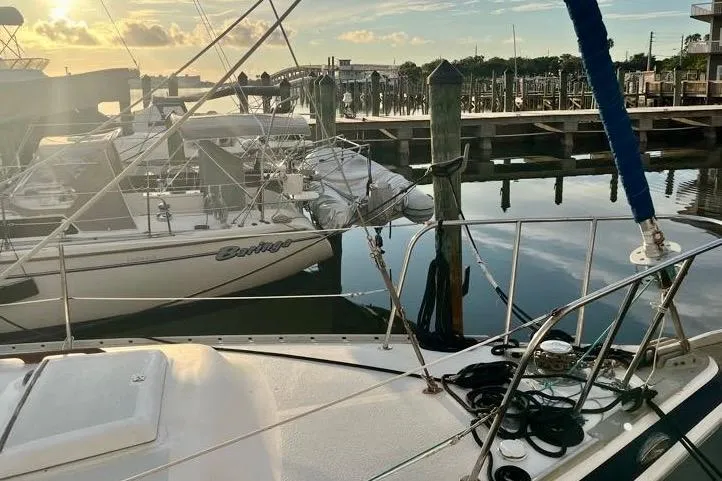 Slide: The Image of 1978 Morgan 415 sailboat docked at a marina during sunset. - 9