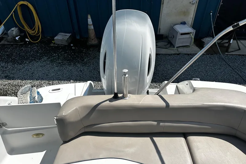 Slide: The Image of 2000 Four Winns Center Console boat interior with seating and engine view. - 10