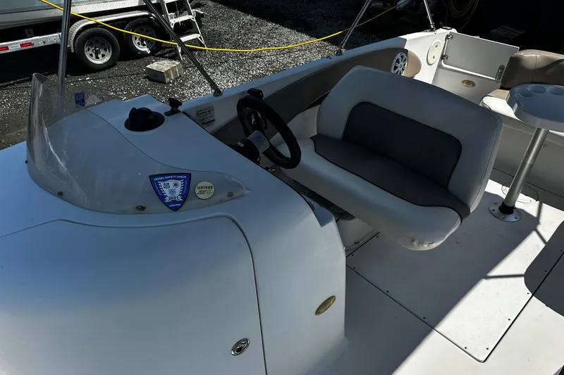 Slide: The Image of 2000 Four Winns Center Console boat interior with steering wheel and seating area. - 4