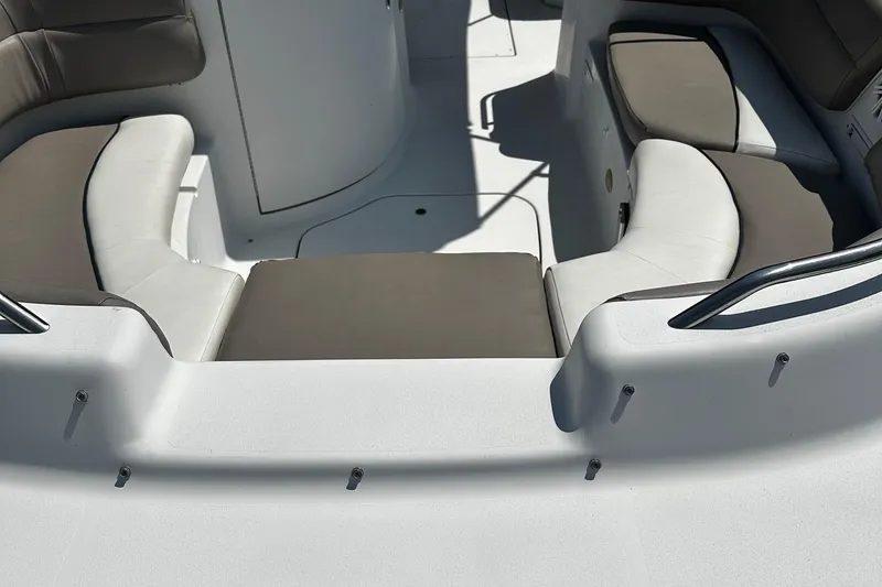 Slide: The Image of 2000 Four Winns Center Console boat interior with cushioned seating and sleek design. - 8