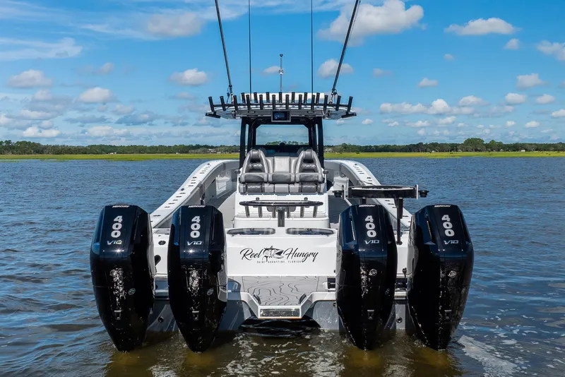 Slide: The Image of 2023 Freeman 47 boat with four Mercury 400 V10 engines on a calm lake. - 11