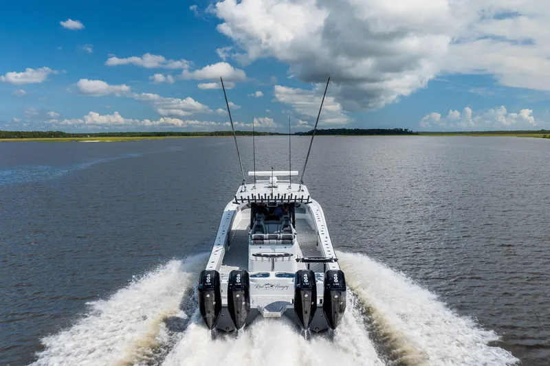 Slide: The Image of 2023 Freeman 47 boat cruising on open water under a partly cloudy sky. - 19