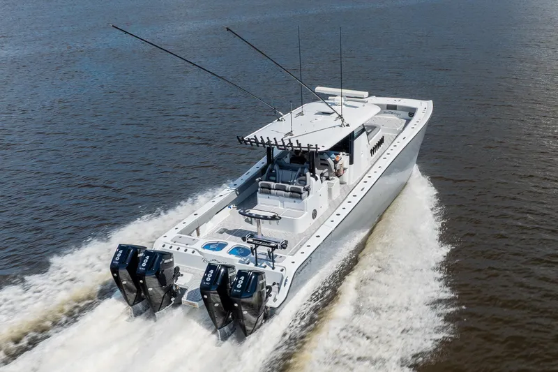 Slide: The Image of 2023 Freeman 47 boat cruising on water, showcasing powerful engines and sleek design. - 21