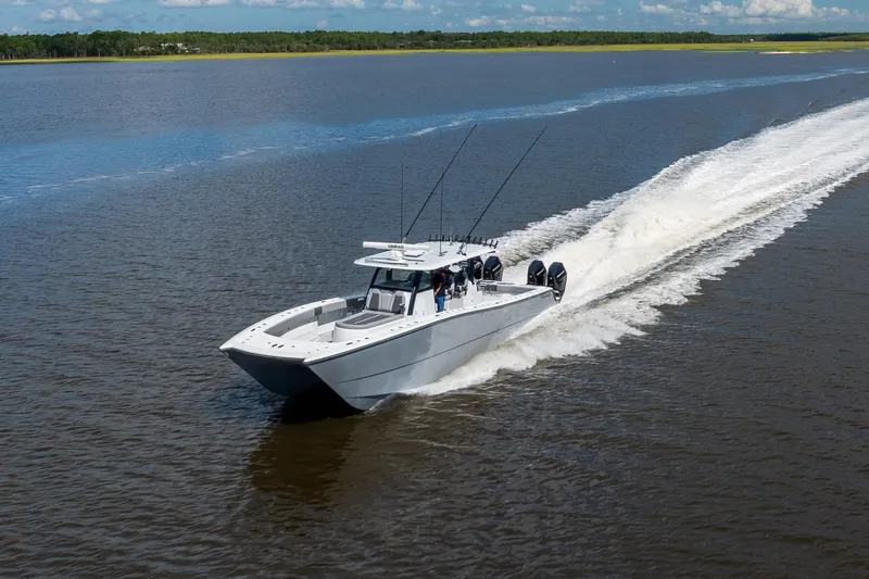 Slide: The Image of 2023 Freeman 47 boat cruising on open water, leaving a wake behind. - 27