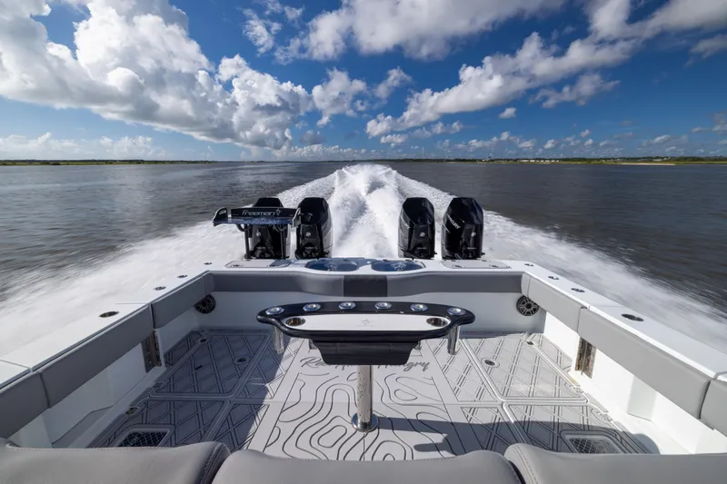 Slide: The Image of 2023 Freeman 47 boat cruising on water, showcasing powerful engines and sleek design. - 31