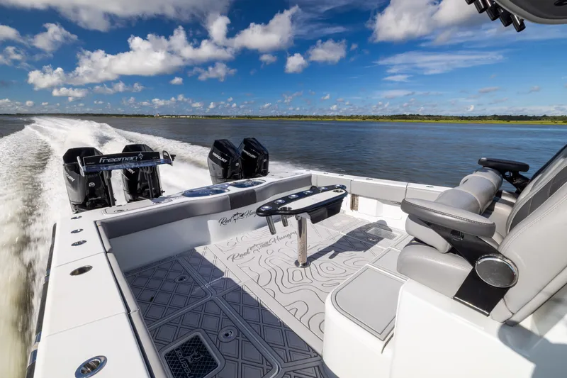Slide: The Image of 2023 Freeman 47 boat cruising on water, featuring sleek design and powerful engines. - 33
