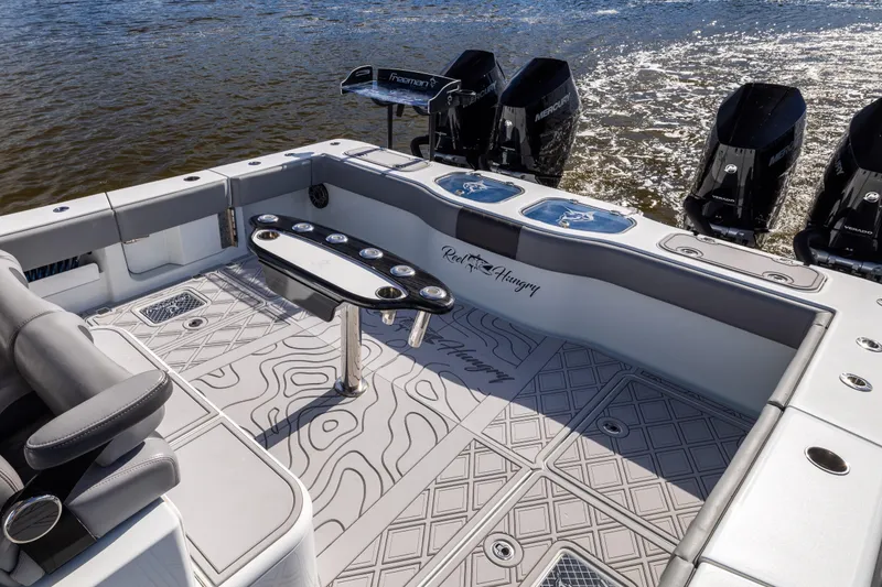 Slide: The Image of 2023 Freeman 47 boat deck with fishing rod holders and powerful outboard engines. - 37