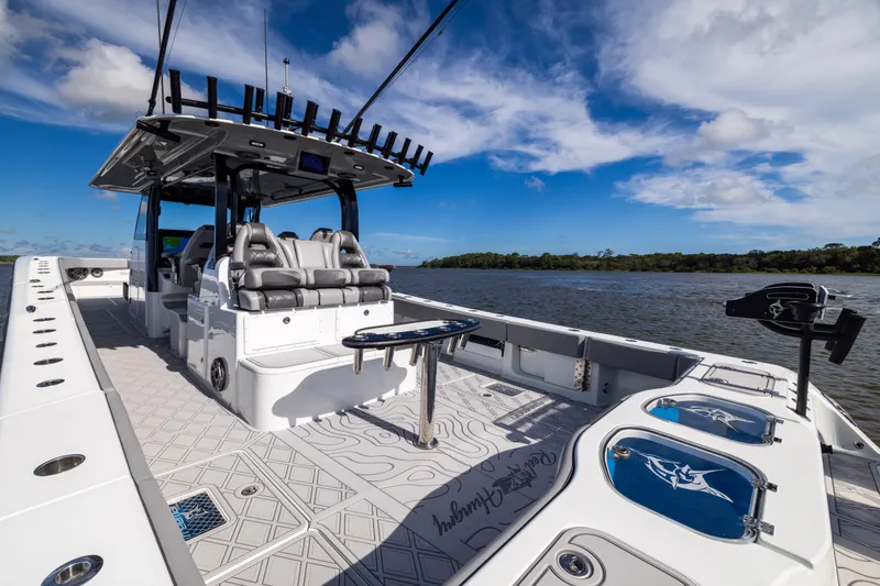 Slide: The Image of Luxurious 2023 Freeman 47 boat with spacious deck and seating, set against a scenic water backdrop. - 43