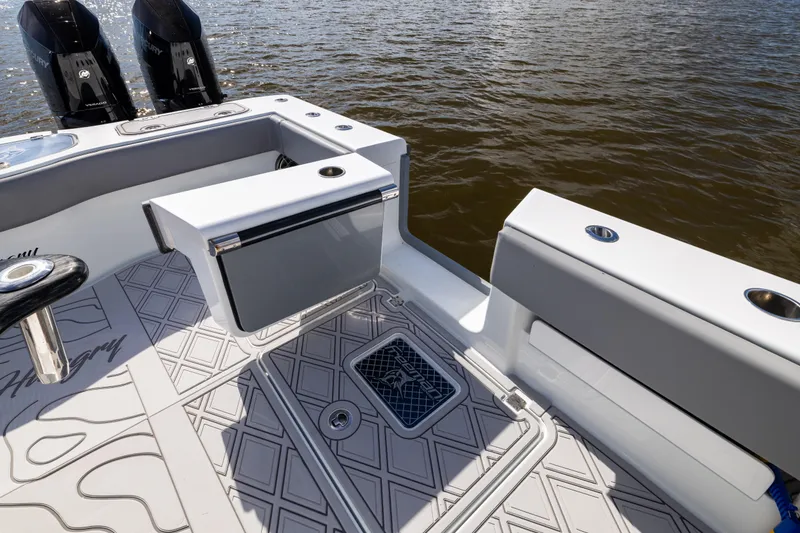 Slide: The Image of 2023 Freeman 47 boat deck with seating and storage, featuring dual Mercury engines. - 47