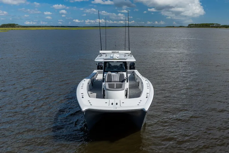 Slide: The Image of 2023 Freeman 47 boat on calm water under a blue sky. - 5