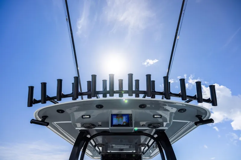 Slide: The Image of 2023 Freeman 47 boat with rod holders, under a clear blue sky. - 52