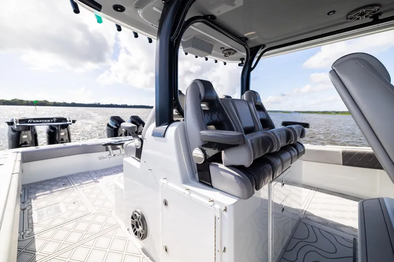 Slide: The Image of 2023 Freeman 47 boat interior with luxurious seating and modern design on open water. - 55