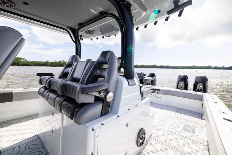 Slide: The Image of 2023 Freeman 47 boat interior with luxury seating and scenic water view. - 56