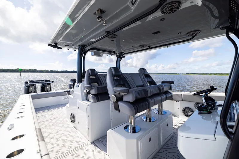 Slide: The Image of 2023 Freeman 47 boat interior with luxurious seating and modern design on open water. - 57