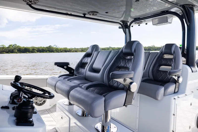 Slide: The Image of Luxurious seating on 2023 Freeman 47 boat, featuring sleek design and modern steering controls. - 59