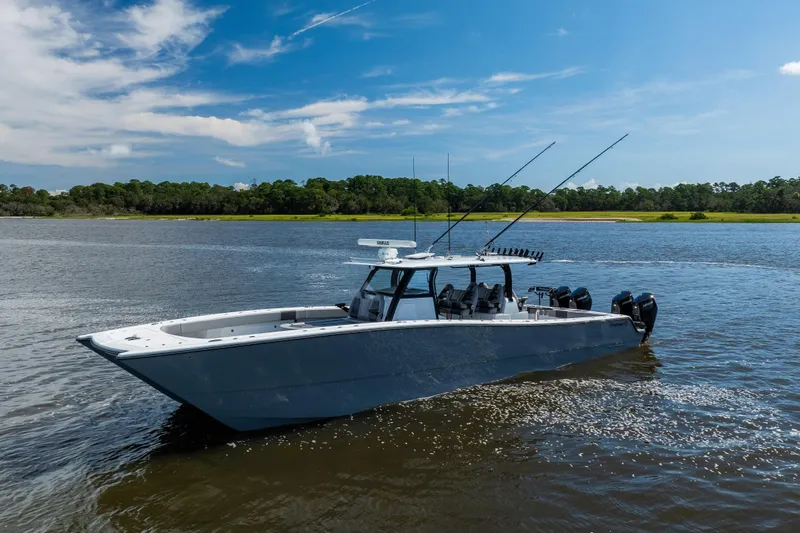 Slide: The Image of 2023 Freeman 47 boat on calm water under a clear blue sky. - 6