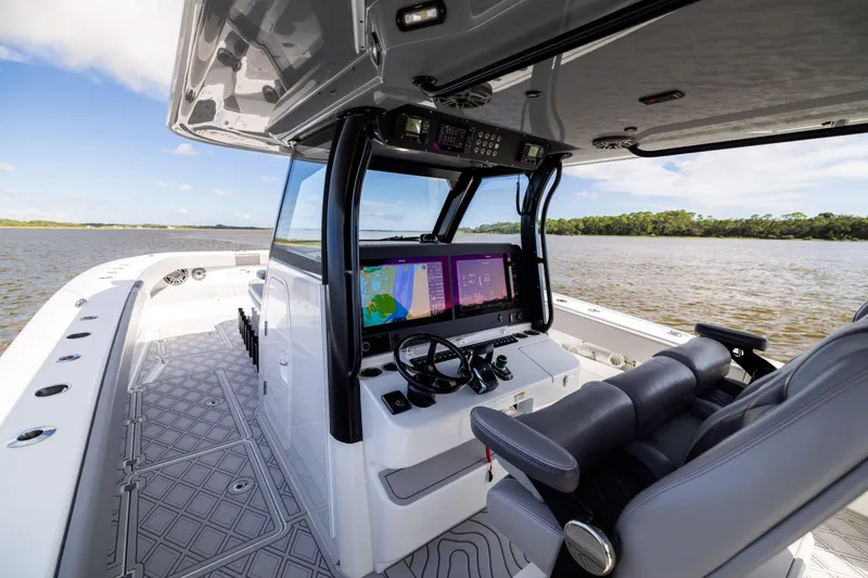 Slide: The Image of 2023 Freeman 47 boat interior with advanced navigation system on a calm waterway. - 65