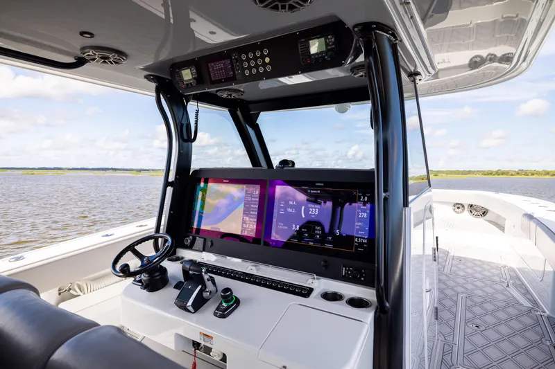 Slide: The Image of Freeman 47 boat cockpit with advanced navigation system, 2023 model, on open water. - 68