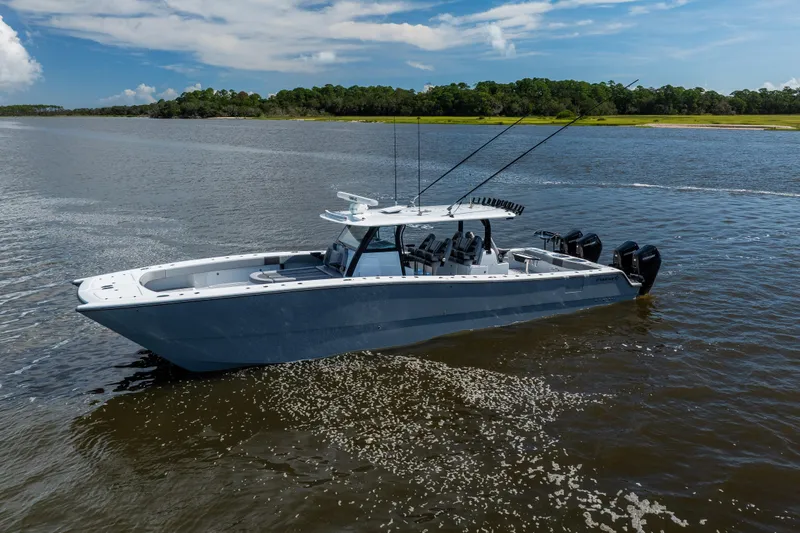 Slide: The Image of 2023 Freeman 47 boat on calm water under a clear blue sky. - 7