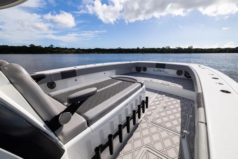 Slide: The Image of Luxurious 2023 Freeman 47 boat interior with seating, rod holders, and scenic water view. - 75