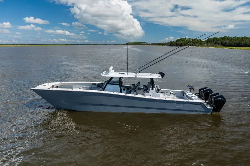 Slide: The Image of 2023 Freeman 47 boat on calm water under a partly cloudy sky. - 8