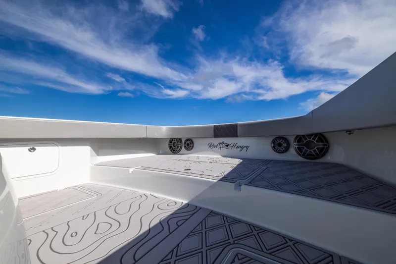 Slide: The Image of 2023 Freeman 47 boat interior with speakers, under a clear blue sky. - 84