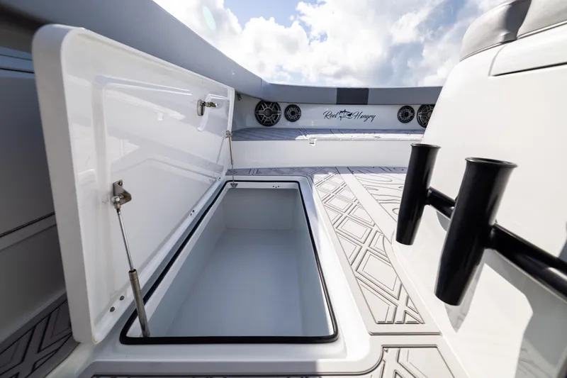Slide: The Image of Open storage compartment on 2023 Freeman 47 boat deck under a cloudy sky. - 85
