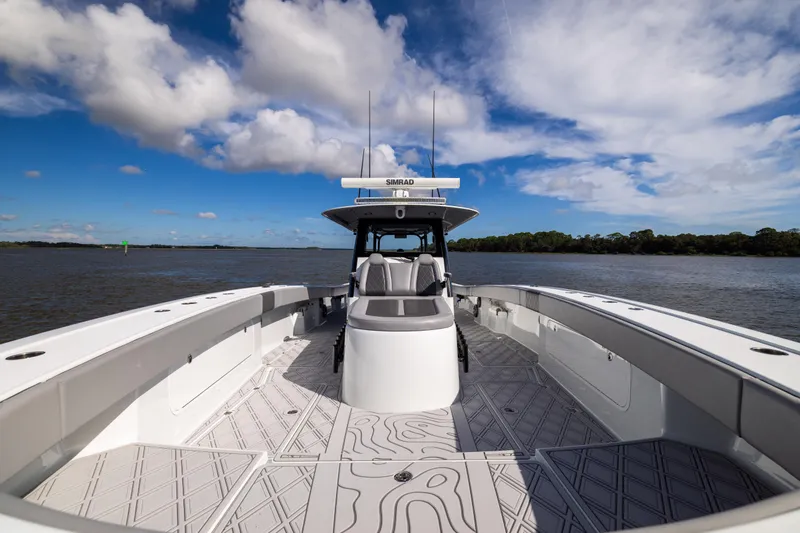 Slide: The Image of 2023 Freeman 47 boat on water, featuring spacious deck and modern design under blue sky. - 89