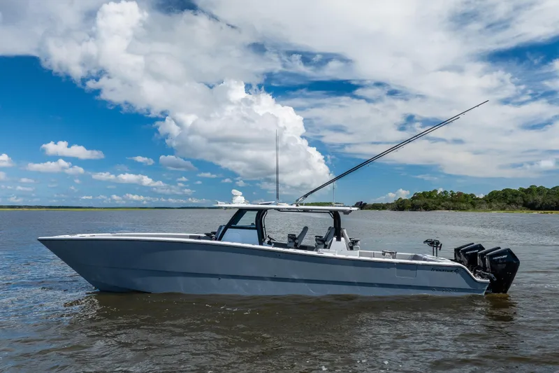 Slide: The Image of 2023 Freeman 47 boat on calm water under a partly cloudy sky. - 9