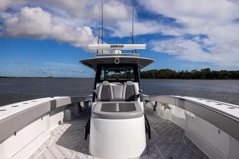 Slide: The Image of 2023 Freeman 47 boat on water, featuring sleek design and advanced navigation equipment. - 90