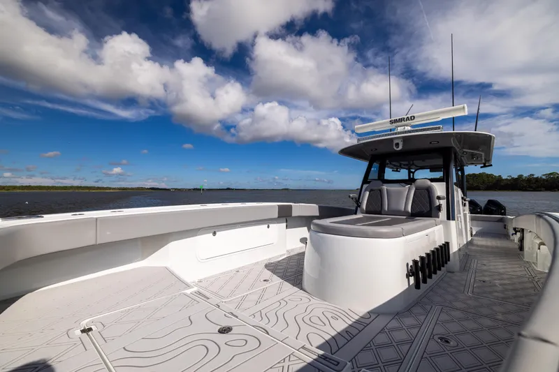 Slide: The Image of 2023 Freeman 47 boat on water, featuring spacious deck and modern design under blue sky. - 92