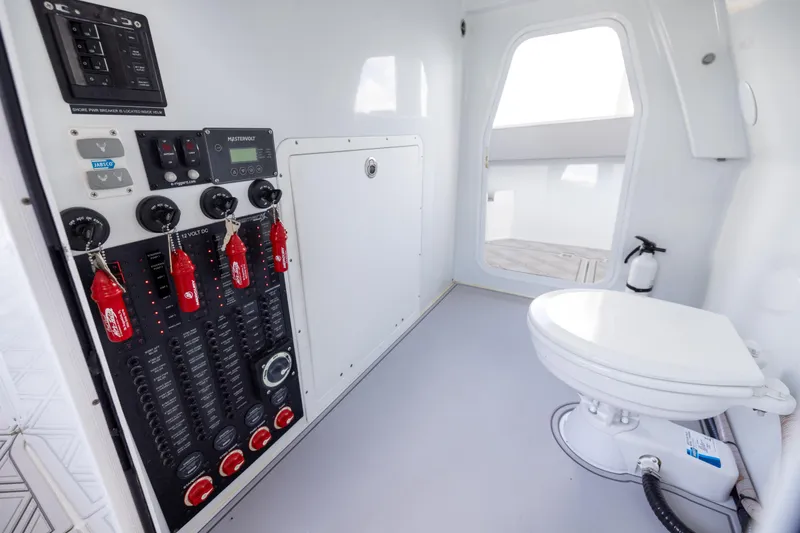 Slide: The Image of 2023 Freeman 47 interior with control panel and marine toilet. - 93