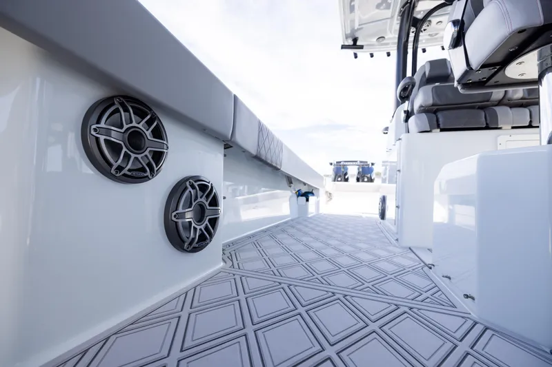 Slide: The Image of 2023 Freeman 47 boat interior with speakers and cushioned seating. - 94