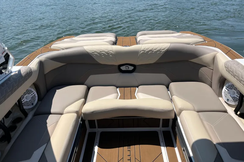 Slide: The Image of Luxurious seating on 2025 Centurion Ri230 boat, featuring beige upholstery and lake backdrop. - 3