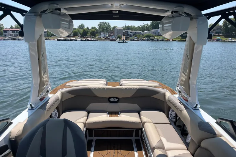 Slide: The Image of Interior view of 2025 Centurion Ri230 boat on a sunny lake. - 6